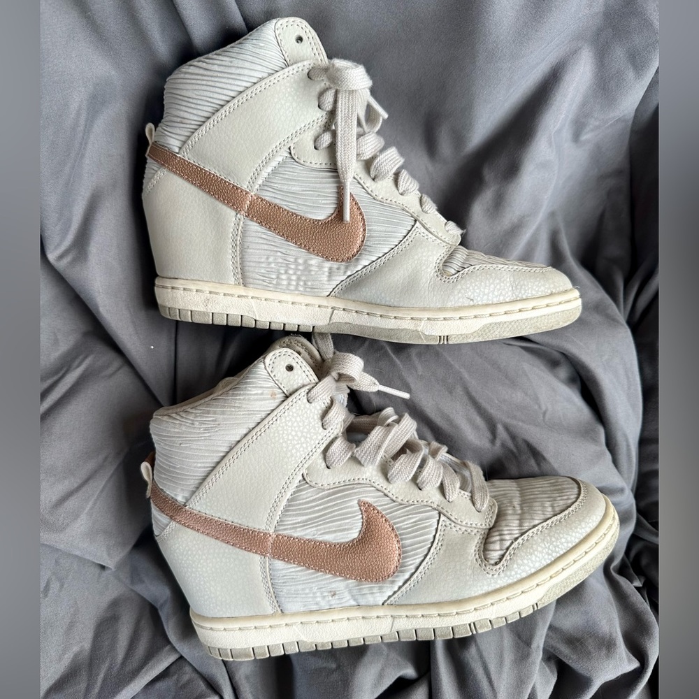 Elevate your sexy style w/ these Nike Dunk Sky Hi bone metallic bronze sneakers.